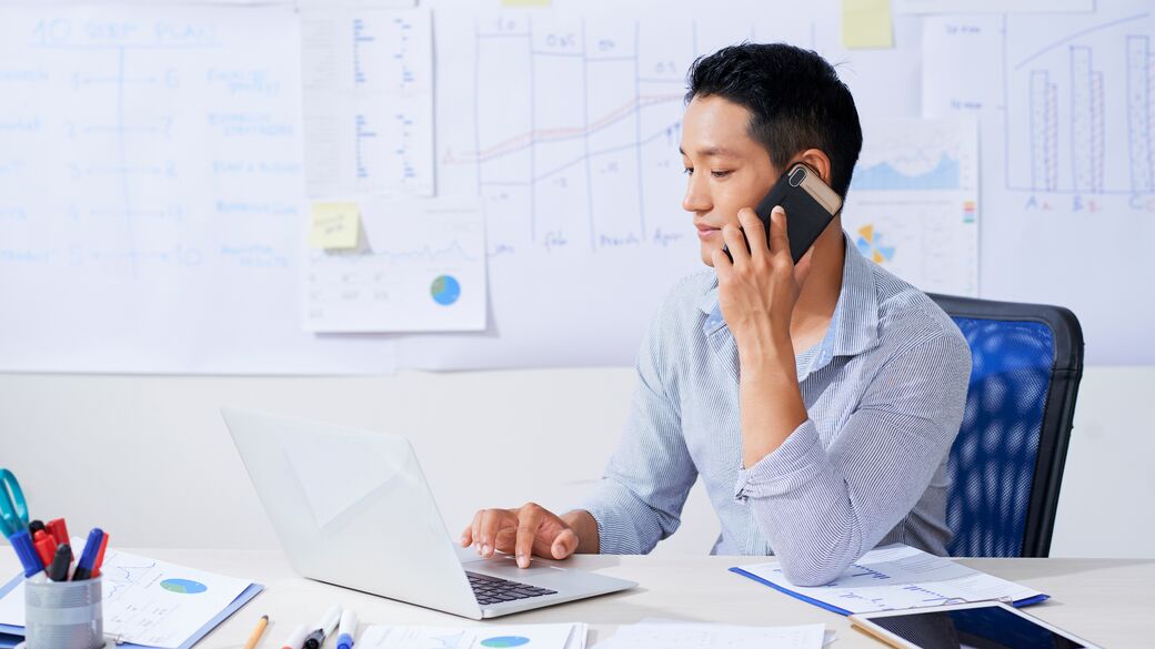 Entrepreneur making  phone call while working