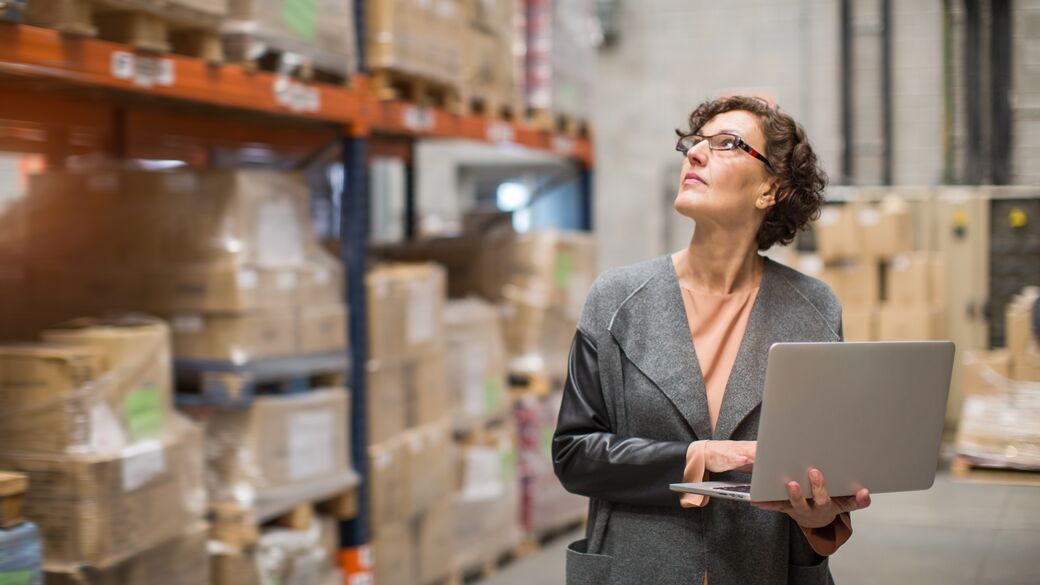 Woman searching inside warehouse Woman searching inside warehouse