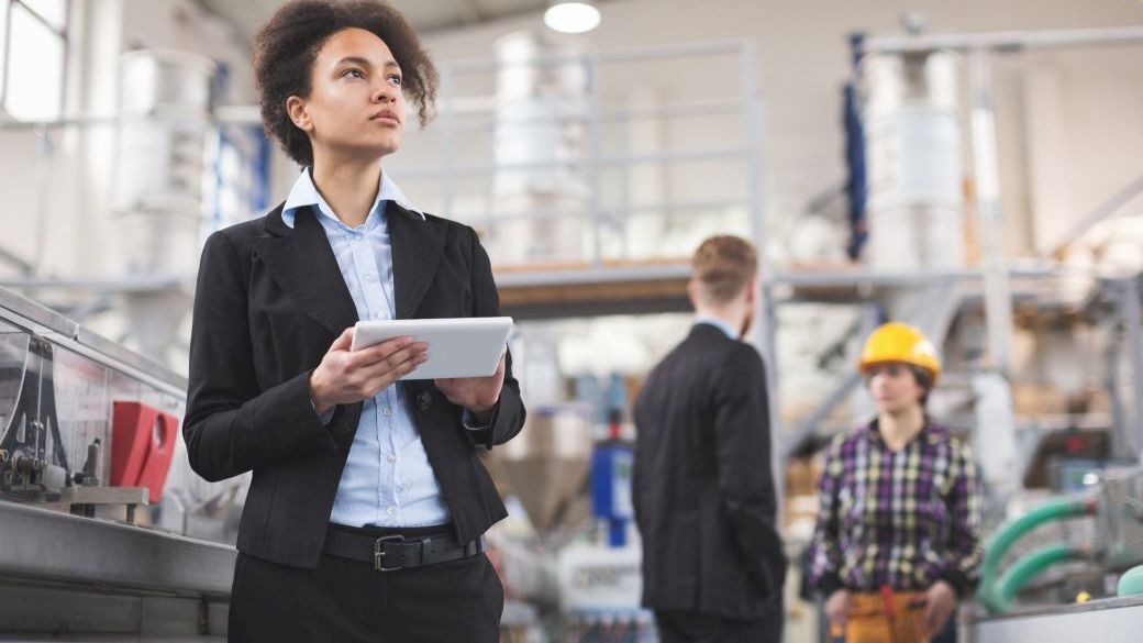 Quality Inspector using a tablet at factory